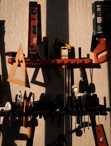 assorted color power tools on wall